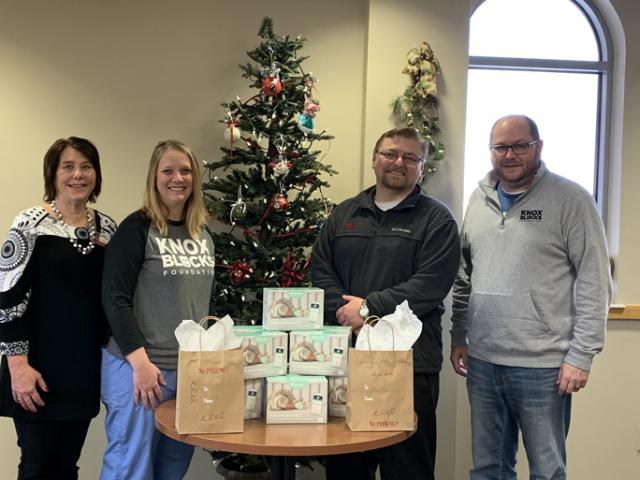 Michelle Schoonover, Jessica Albertsen, Tyler Henkle and Peter Eikamp with smart sock donation