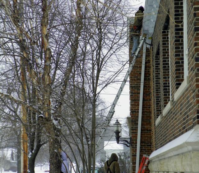 Workers replaced gutters that allowed water to leak, at times, into the Vinton library.