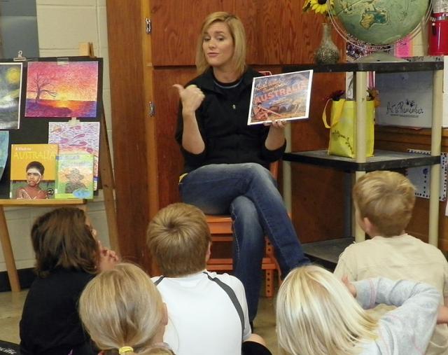 Art teacher Lindsey Otto helps prepare students for a project by reading a book about Australia.