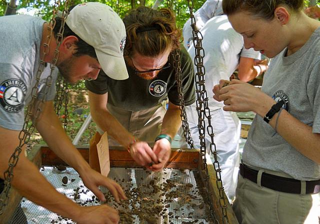Julianne, Jess and Eric screening soil as they look for Native American artifacts in Iowa.