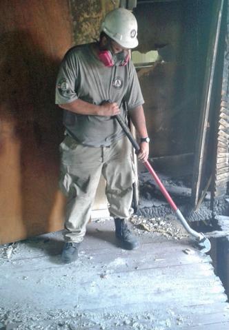 Ian continues demolition on a house damaged by a fire to be revitalized and reused for office space.