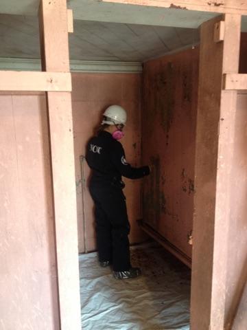  Maple 4 member Emily Schaeffer wet scrapes lead paint at Lennox College in Hopkinton, IA