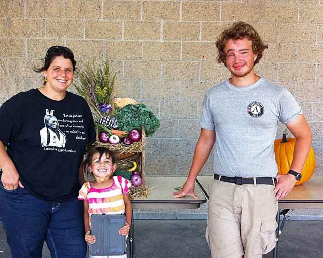 Member John Kelley poses with Earth Tipi founder Shannon Freed and Raven at the Wazi Paha Festival.