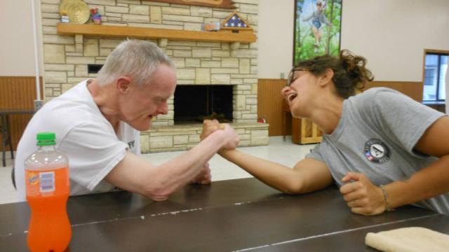 Jamie arm wrestles one of her campers and loses