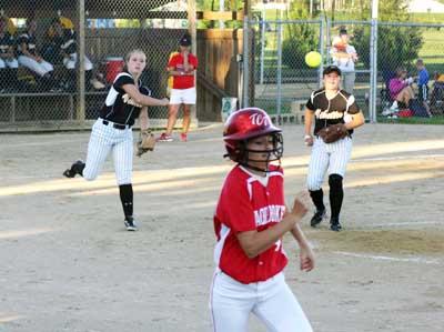 Vikette pitcher Maddie Cornell fires to first base as teammate Katie Henderson looks on.