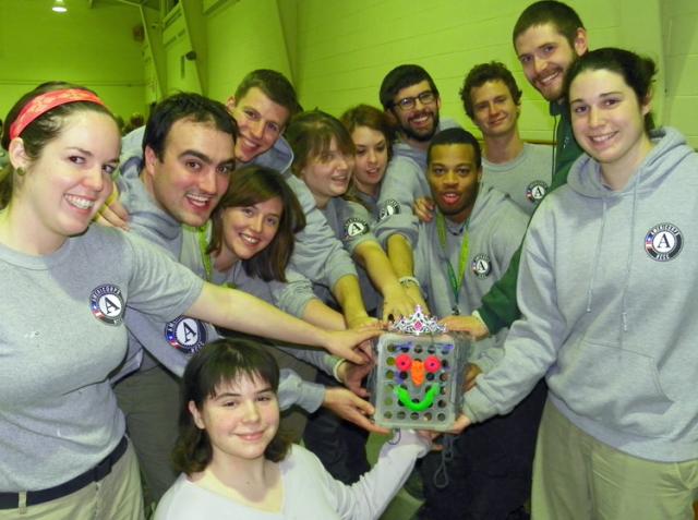 Maple 4 members hold their unusual trophy after winning a uniquely AmeriCorps contest.
