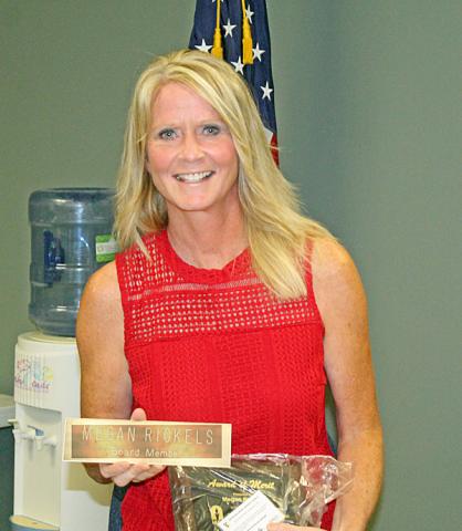 Megan Rickels holds her name plate and plaque at her last meeting as VS school board member.