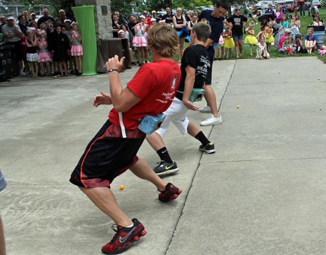 Chris Merchant, Max Griffith and Grant Sagan try to shake ping pong balls from a box.