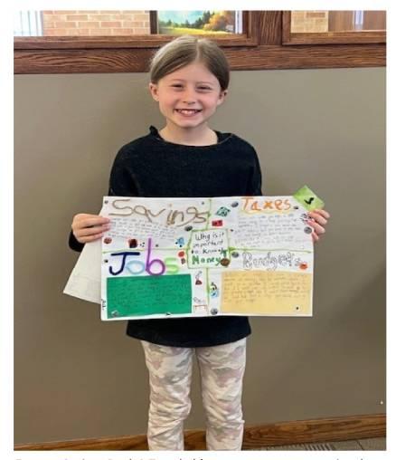 Mazy Druschel with her winning Money Smart poster