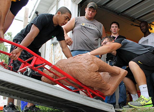 Team citizenship: Viking football players helped a couple move into Vinton on Wednesday.