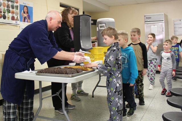 Mr. Murray served cookies to the nearly 450 students after they earn 7,500 Viking Spirit tickets
