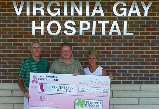 Rick and Paula Murphy present VGH Administrator Mike Riege $11,500 raised with annual golf event.