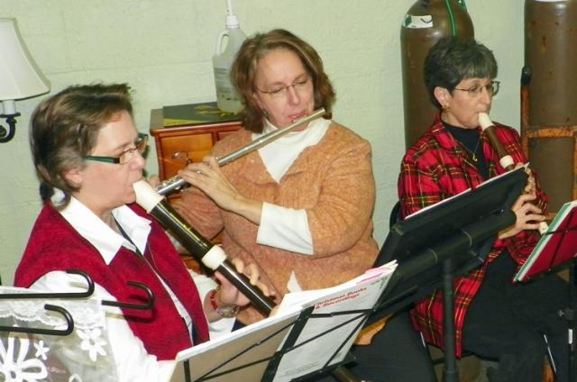 Judy Trygstad, left, and Barb Glime, right, and Jody Bierschenk are in the What Cheer Winds Band.