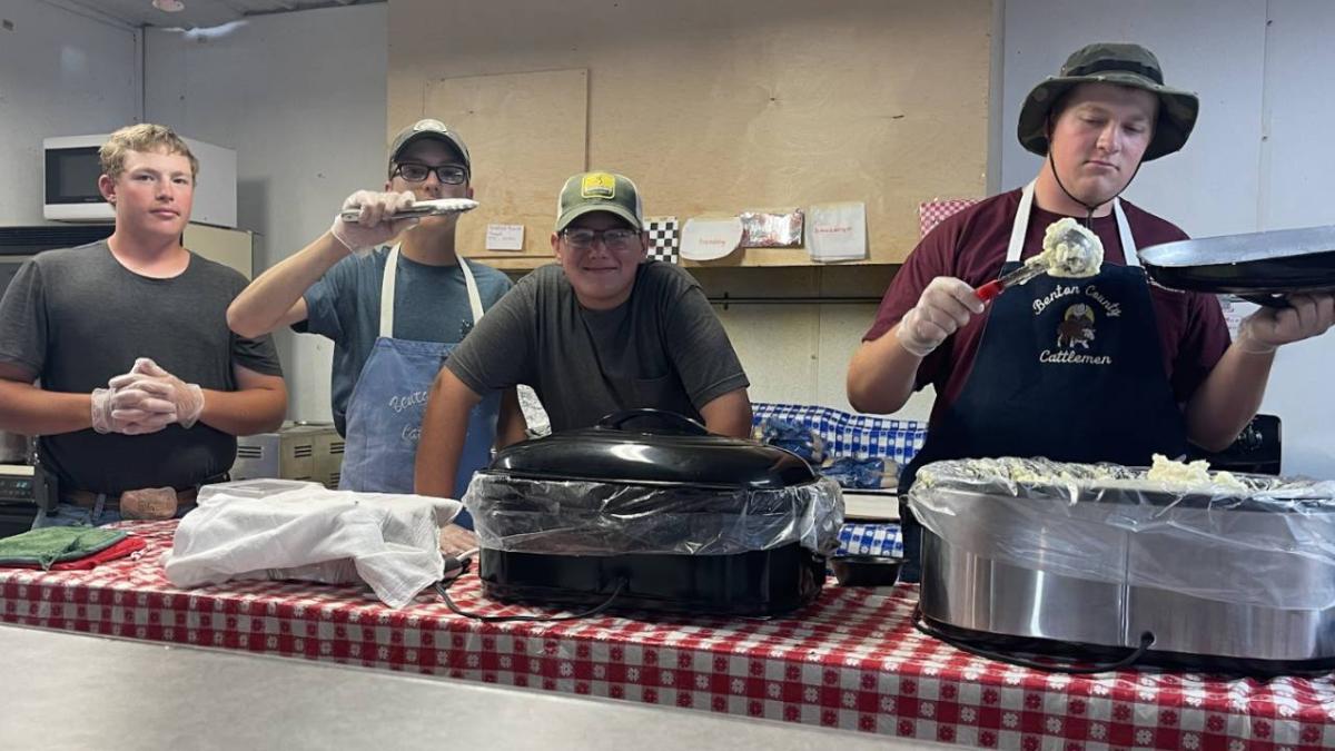 Christopher Fleming, Austin Noe, Evan Lopata, and Andrew Pingenot enjoyed working at the Cattleman’s Booth and serving customers.
