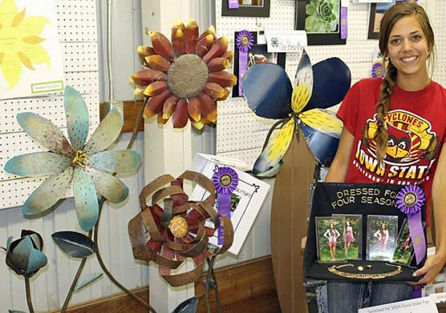 Nicole Lowe welded flowers from old car hoods and created an 'all-seasons' clothing/photo display.