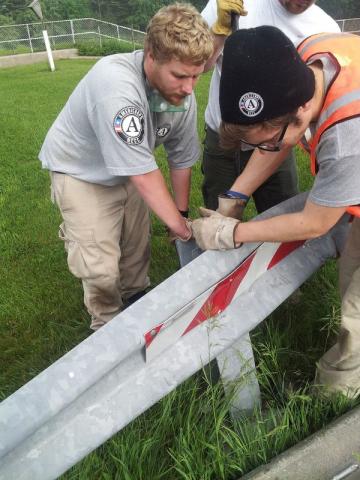 Matthew Kimmett and Vincent Beyer install a guard rail.