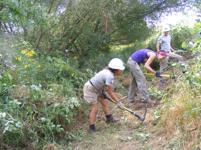 Jessica Rivas, supervisor Ellie and Justin Livergood eorking on the Kinnickinnic River trail.
