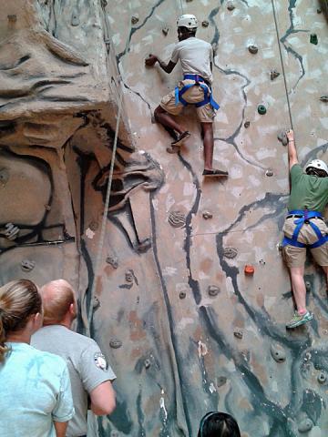 Nick tests for his belaying certification with the assistance of his climber, Christian.