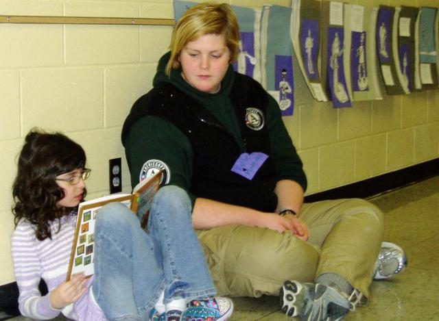 Tilford student Lucille Lindsey gets help with reading from Green Team member Kellie Mattingly.