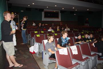 Hawkeye and Cyclone fans watch the preshow, separated by caution tape, at the theatre last Saturday