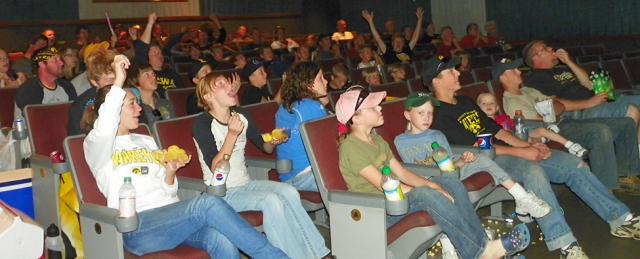Hawkeye fans cheer another touchdown as they watch Iowa/ISU game on big screen at Palace.