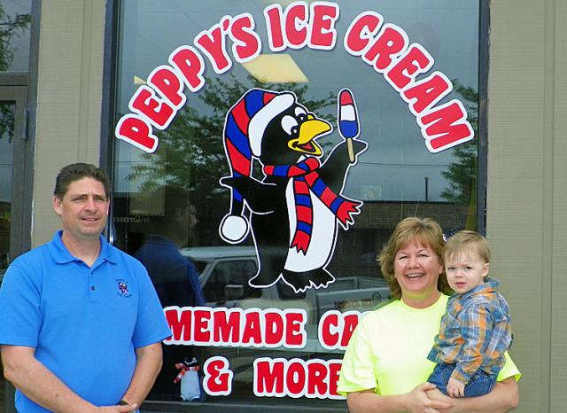 Tim and Denise Bird (holding grandson Riley) opened Peppy's ice cream shop Wednesday in Vinton.
