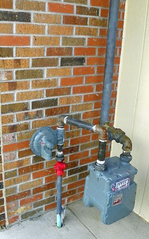 The gas meter was blown into this wall, breaking both the large pipes and part of the brick.