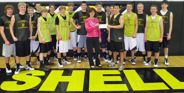 Senior Viking Logan Williams presents Pink Night profits of $2,640 to Monica Stark of VGH.