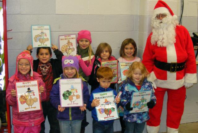 VPRD Thanksgiving Coloring Contest winners pose with Santa before riding in the parade.
