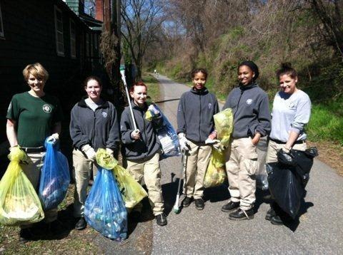 Spruce Six takes a much needed break after filling bags with trash at a river cleanup.