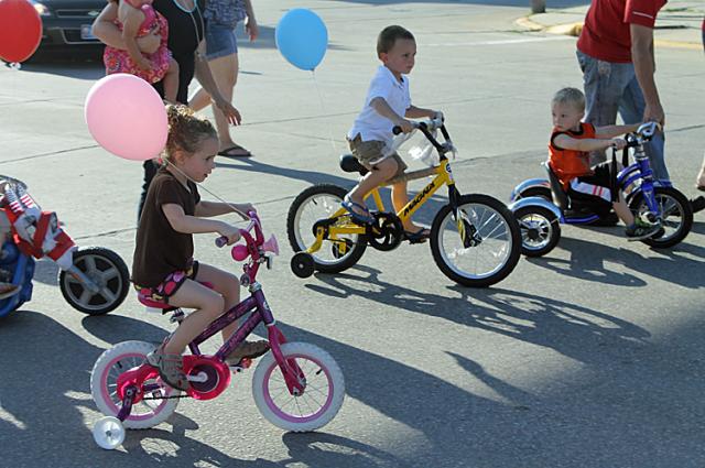 Children ride from the FSB parking lot to the courthouse during the Kiddie Parade.