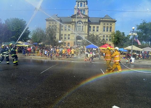 Rainbows covered the street as firefighters from more than 100 teams competed in water fights.