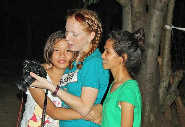 World Race: Two girls from Thailand gather around Rose Huber and her camera.