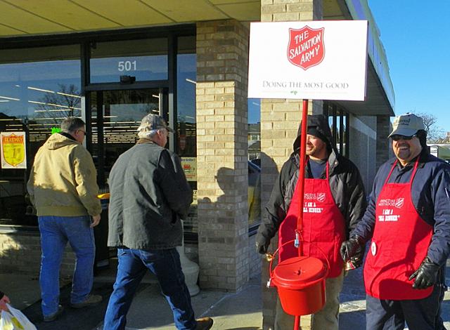 Rev. Bob Gaston, right, and a Salvation Army volunteer ring bells at Fareway Wednesday morning.