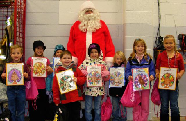 Kindergarten thru 3rd grade coloring contest winners at VPRD, along with Santa.