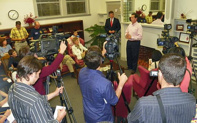 Cameras from a variety of media outlets surround Rick Santorum in the Vinton Public Library Monday.