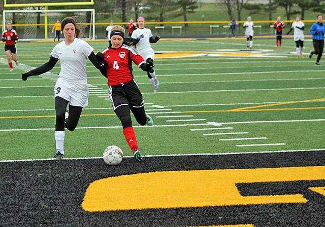 Grace Milroy races for position vs. Western Dubuque.