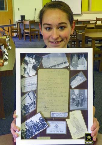 Shelby McDonald holds the shadow box she made for her grandfather, Raymond.