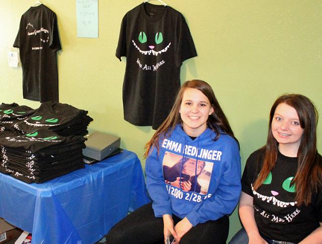 Emma Redlinger's cousin, Kelsey Williams, and friend Kamryn Robinson, sell T-shirts Saturday.