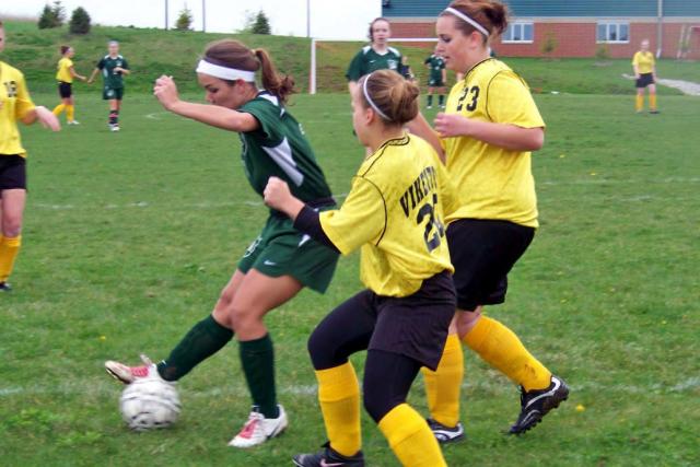 Two Vikettes defend against a Columbus player during home game Monday.