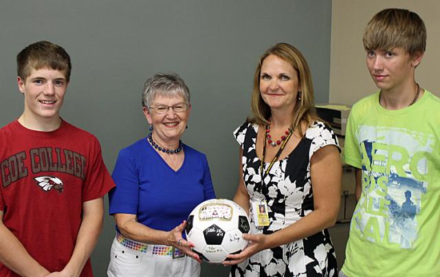 Soccer players Marshall Mullinex & Cody Sojka presented a ball to Sue Gates and Supt. Hainstock.