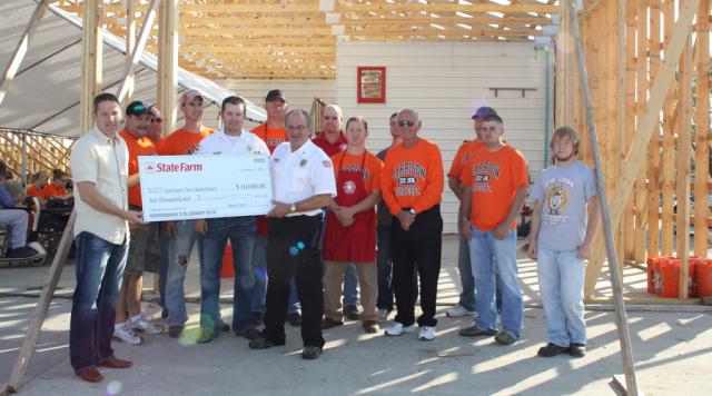 Garrison Fire Department receives $10,000 from State Farm Insurance to help restore EMS building.