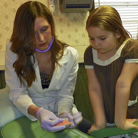 Emma Hicks gets a close look at how a cavity is filled.