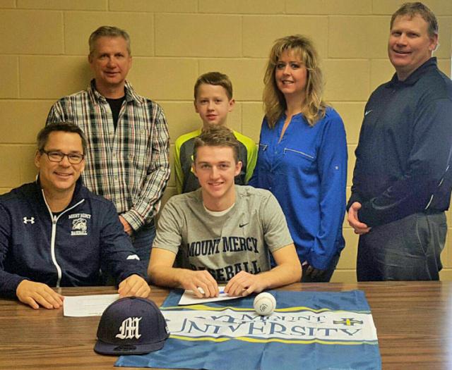 Tyler Rippel with coaches Dahm and Struve, parents Jeff and Hayley and younger brother, Chase.