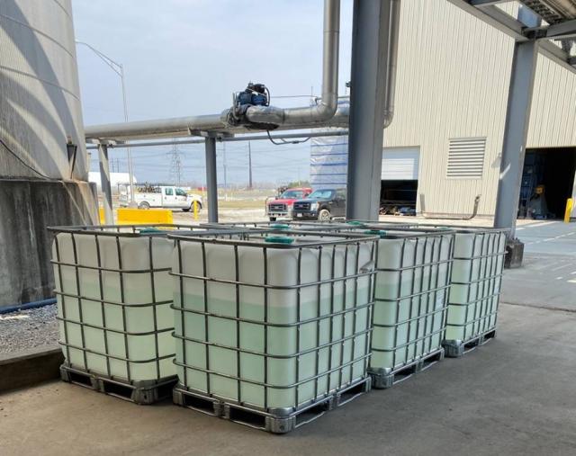 Totes of ethanol from Southwest Iowa Renewable Energy prepared shipment to Iowa Prison Industries