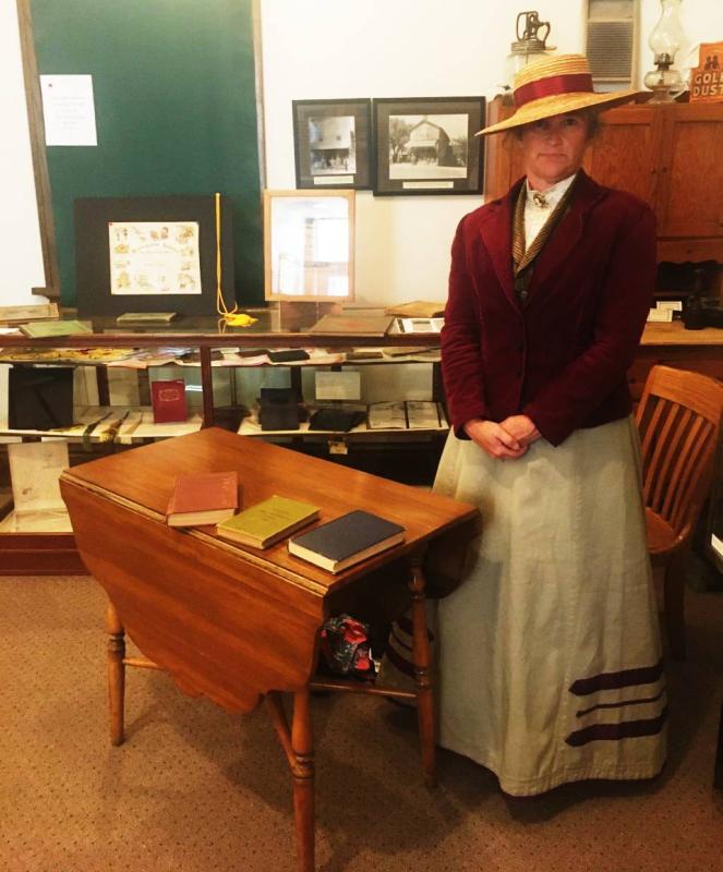 Ann Cejka, Ushers Ferry Historic Village Program Coordinator, assumes her stern schoolmarm stance for a talk on one room schools at the Center Point Historical Society Depot Museum