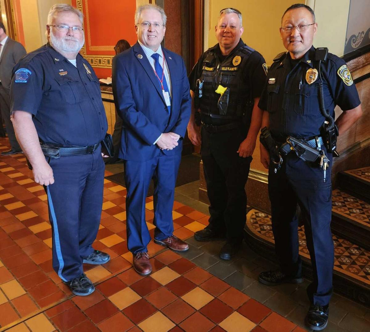 Police Chiefs Advocate for House File 967 at the Capital. From right: Vinton Police Chief Ted Paxton, Belle Plaine Police Chief Kris Hudson, Rep. Gerhold, and Osceola Police Chief Marty Duffus.