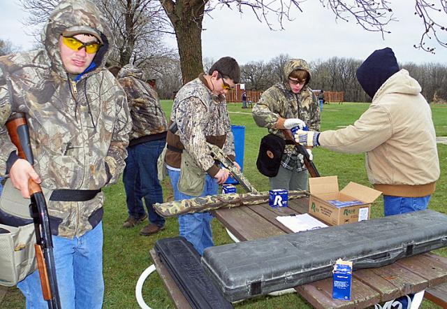 Red Cedar Shooters exchange shells in between rounds.