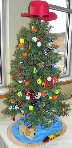 A boys tree made by Coleen Long features gifts and toys for them
