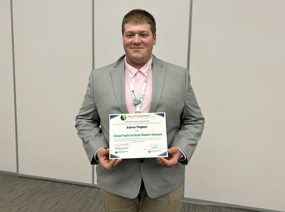 Andrew Pingenot with his certificate of participation in the Global Youth Institute.